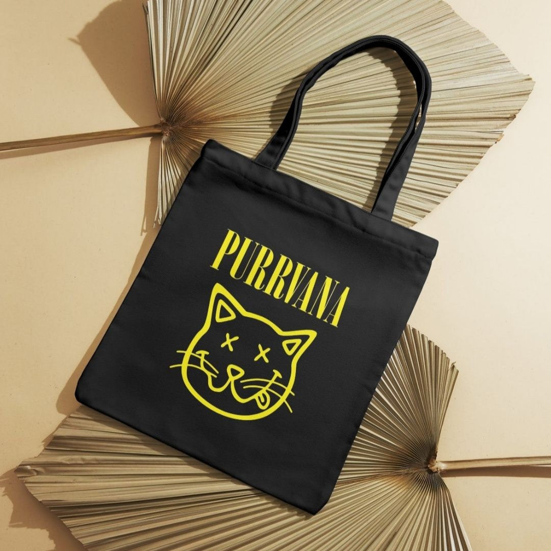 Tote bag preta Purrvana com rosto de gato amarelo em estilo grunge